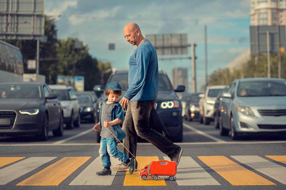 Father and son crossing the street.