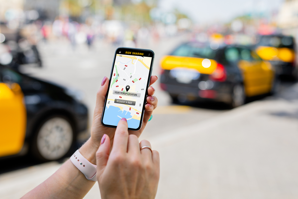 Passenger using rideshare app to book a ride.
