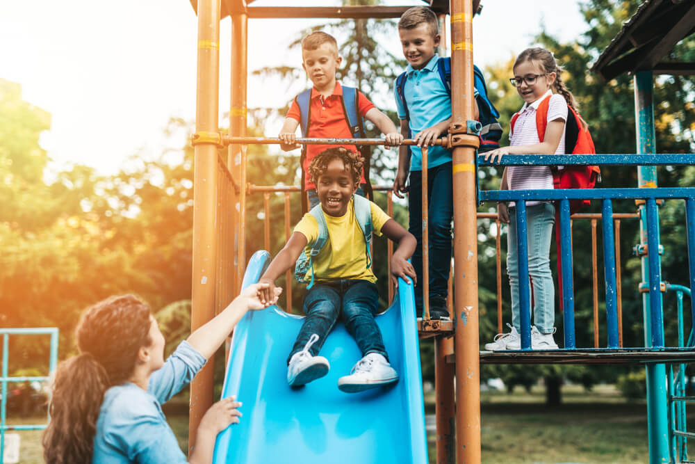 School children playing on the slide.