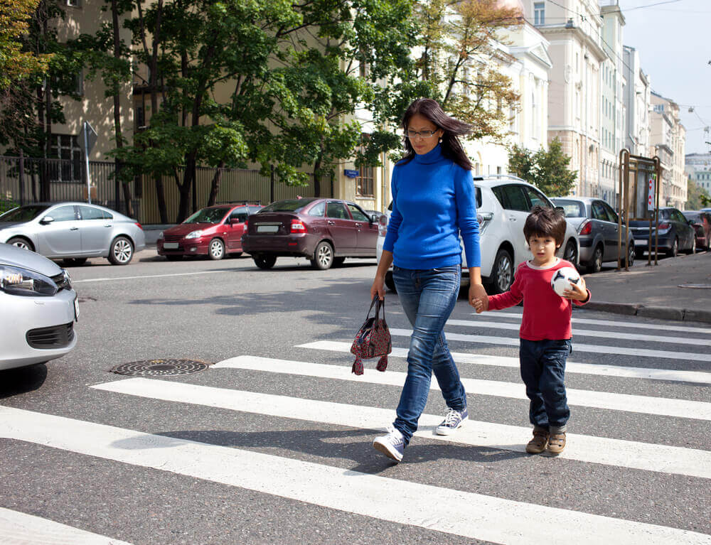 Mother and child crossing the street.