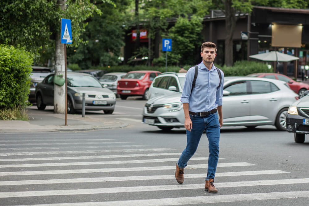 Man crossing the pedestrian lane.